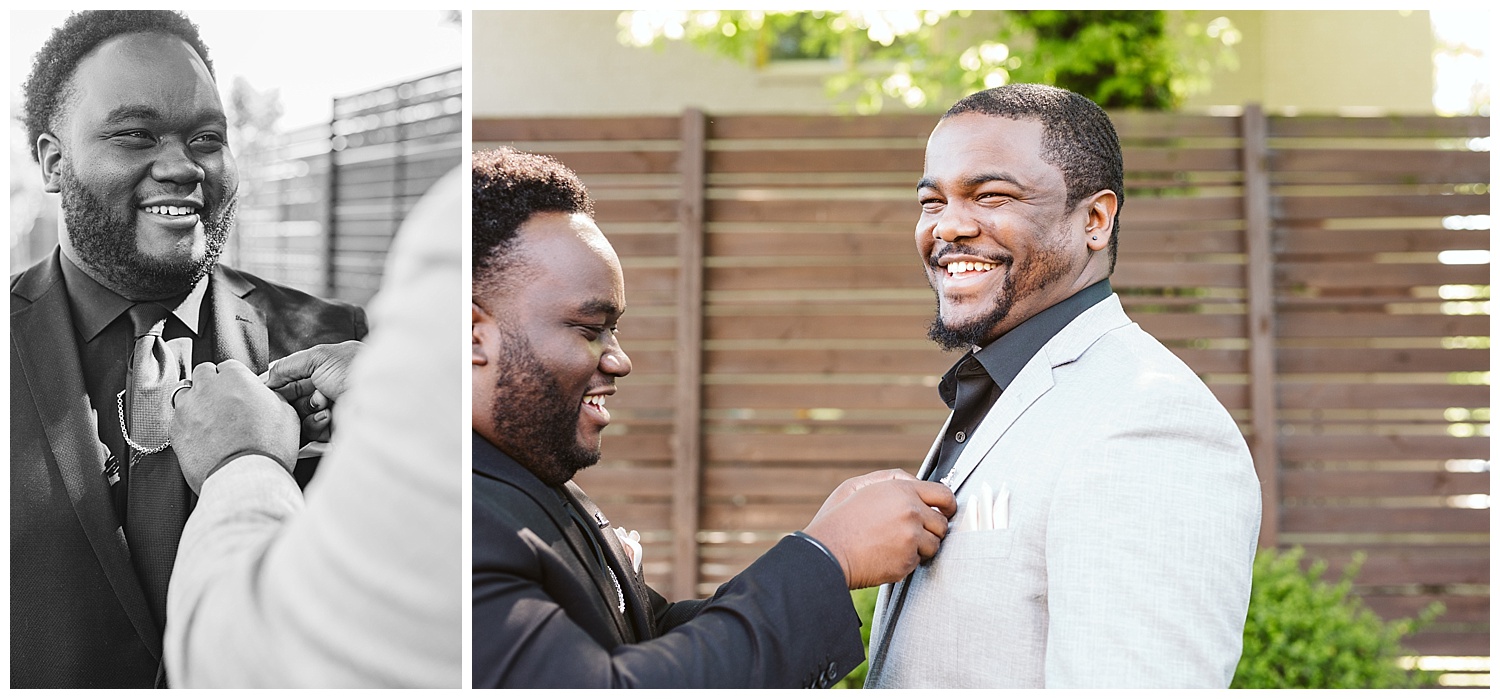 man in black suit pinning chess pin onto friend in gray suit, The Cordelle, Nashville wedding photography, Country Music Hall of Fame wedding reception, Tennessee wedding Planning, Wedding Inspiration, Engagement Inspiration, Downtown Nashville, The Cordelle Nashville, wedding venue