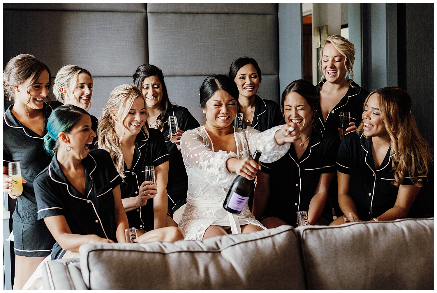 bride popping champagne bottle with bridesmaids, Nashville wedding photography, Country Music Hall of Fame wedding reception, Tennessee wedding Planning, Wedding Inspiration, Downtown Nashville