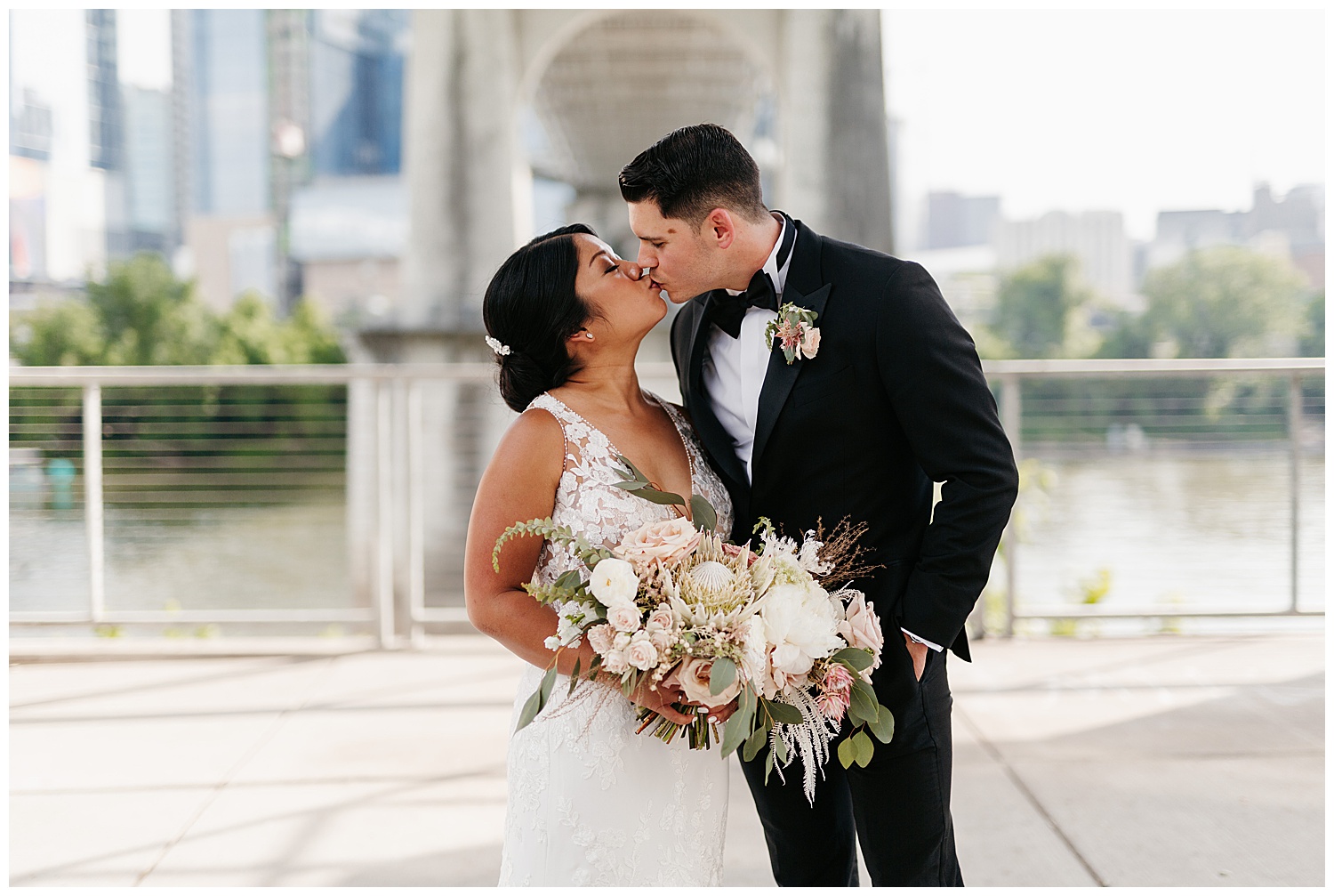 bride and groom kissing under The Pedestrian Bridge, groomsmen photos under The Pedestrian Bridge, Nashville wedding photography, Country Music Hall of Fame wedding reception, Tennessee wedding Planning, Wedding Inspiration, Downtown Nashville